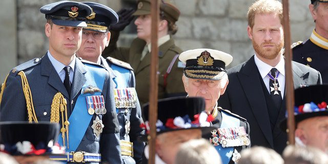 Prince William, King Charles III and Prince Harry view the coffin of Queen Elizabeth during the state funeral at Westminster Abbey on September 19, 2022 in London.