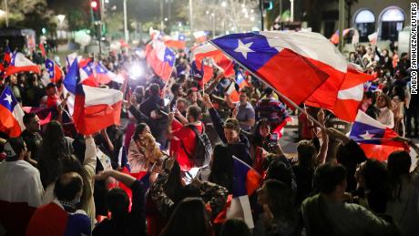 Some waved flags while celebrating the rejection of the proposed constitution.