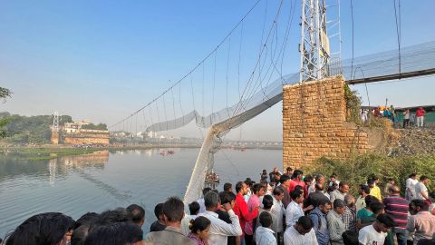 People gather as rescuers search for survivors after a suspension bridge collapsed in Morbi in the western state of Gujarat, India, October 31, 2022. 